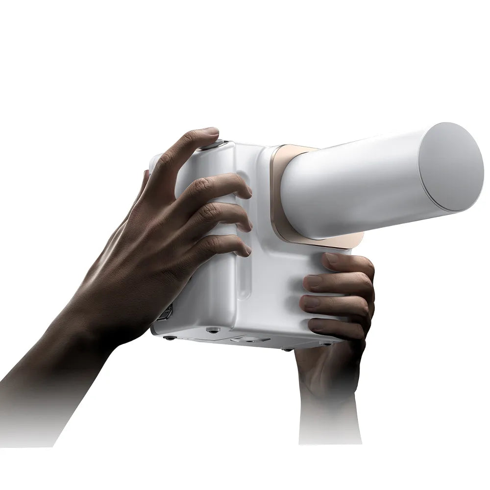 Beetle Dental portable dental x ray machine handheld white device held by hands for clinic imaging