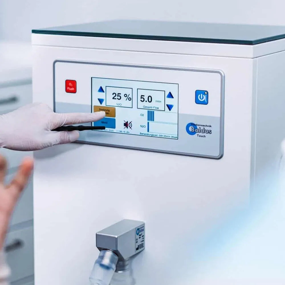 Beetle Dental oxygen nitrous oxide mixer unit for dental clinics with touchscreen display and gloved hand