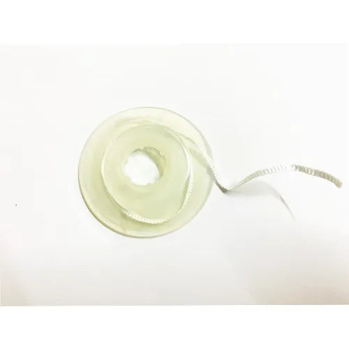 Spool of white braided fiber ribbon for splinting and restorations Bioloren Infibra Ribbond dental reinforcement