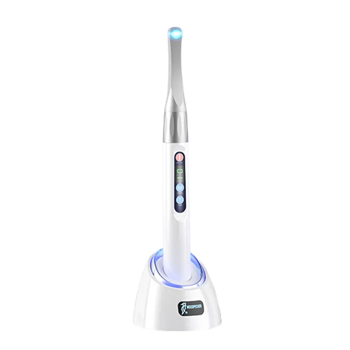 Beetle Dental Woodpecker ILED Plus curing light handheld LED dental light on a white charging base with blue tip