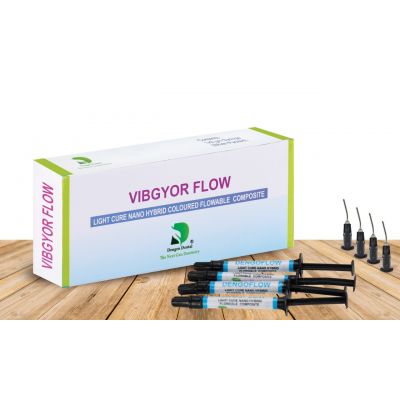 Dengen VIBGYOR Flow dental composite box with four syringes and dispensing tips on wooden surface