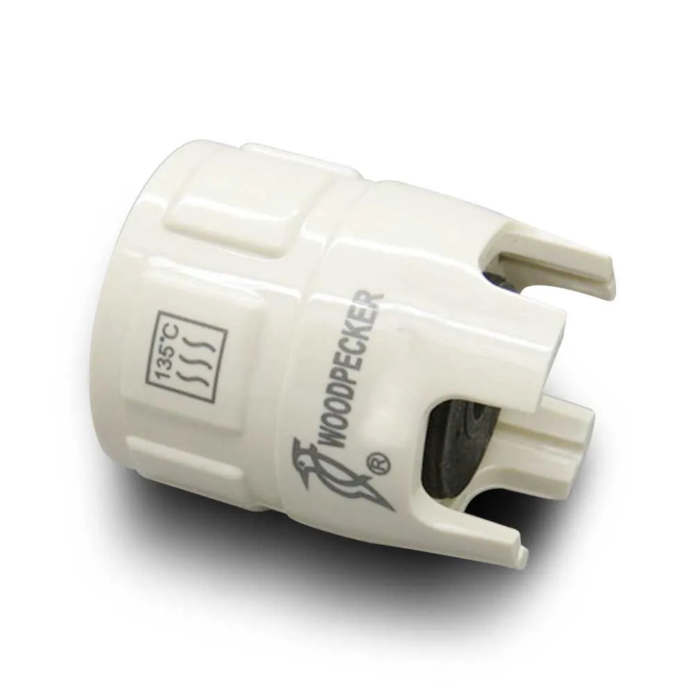 White Woodpecker branded plastic scaler tip adapter with 135C autoclave mark for woodpecker scaler tip torque wrench