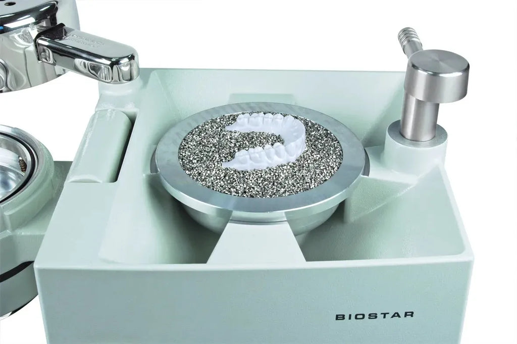 Biostar dental vacuum forming tray with dental model resting on Scheu stainless steel pellets 1 kg for lab thermoforming