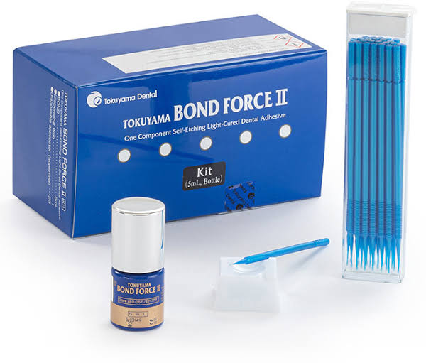 Tokuyama Bond Force II kit containing dental adhesive, applicator brush, and mixing tips for dental use