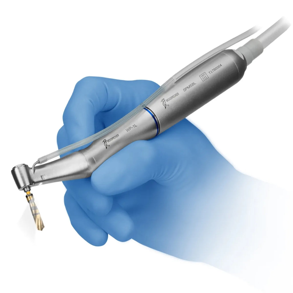 Woodpecker LED implant handpiece stainless steel dental implant drill held in blue gloved hand