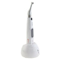 Woodpecker Motopex endomotor for dentists. White cordless endomotor handpiece with contra angle head on charging base