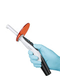 Woodpecker O Light curing light handheld in gloved hand with orange protective shield and ergonomic black handle