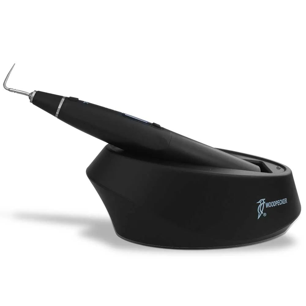 Woodpecker Obturation Pen for dentists. Black cordless obturation pen with angled tip in charging base