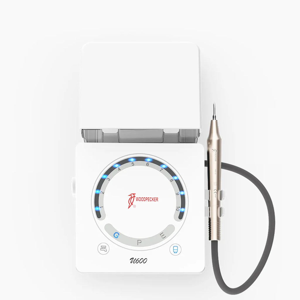White dental unit top view with metallic handpiece and dial LED lights Woodpecker U-600 LED ultrasonic scaler